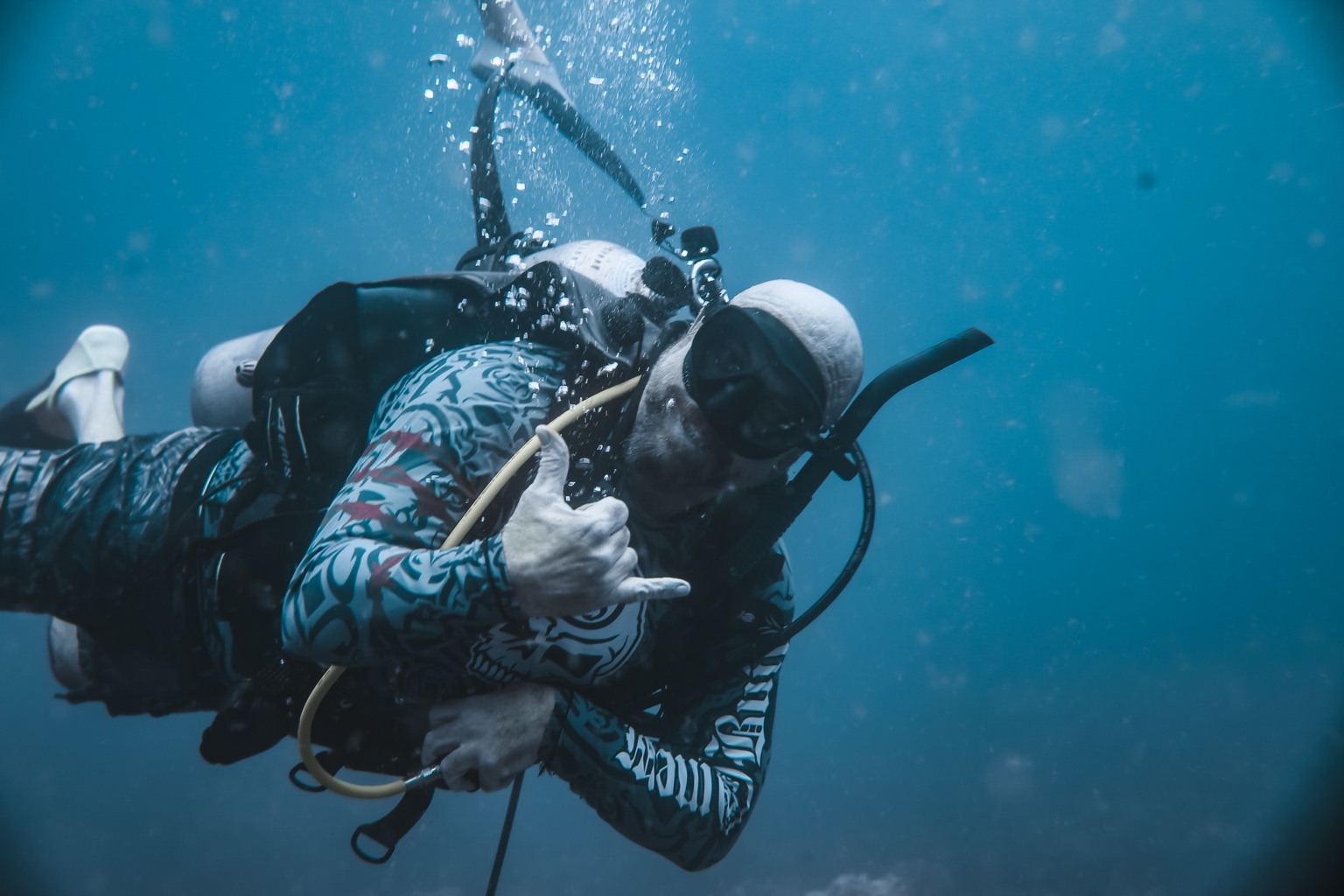 Jake Farmer demonstrating an underwater hand signal while diving